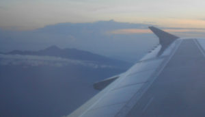 The wing of a Cebu Pacific plane flying past Mount Apo, Mindanao, The Philippines. Cebu Pacific is one the discount carriers that serves The Philippines.